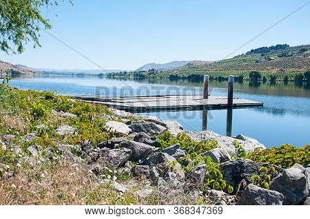 River Side With Dock Landscape With Mountains And Clear Blue Sky.  Columbia River In Washington Stat
