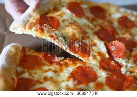 Close-up Of Homemade Delicious Round Shaped Pizza Piece. Hot Yummy Meat Double Cheese Mozzarella Par