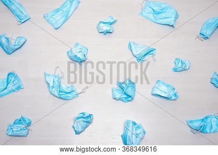 Used Hygienic Masks Scattered On The Floor. Infectious Waste, Prevented Virus Covid-19 By Separating