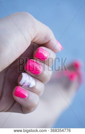 Womans Hand Showing Her Semipermanent Manicure. Pink Colour