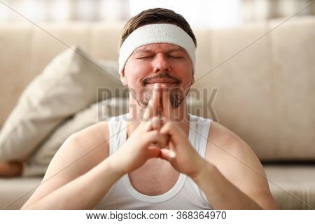 Man During Self-isolation After Sports Meditates. Force Yourself To Fight Laziness. Psychological As