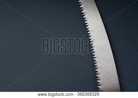 Sharp Saw Teeth. Wood Saw Blade On A Dark Background. Copy Space.