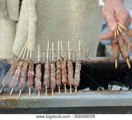Bbq Of Many Arrosticini Of Sheep's Meat From Abruzzo Region In Italy