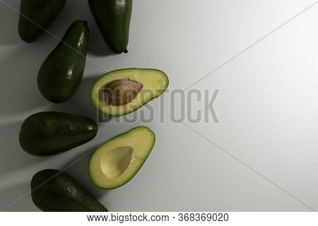 Ripe Avocado Fruits Whole And Sliced On A White Background. Top View.