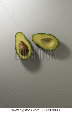Ripe Avocado Fruit Cut In Half. Top View. Copy Space
