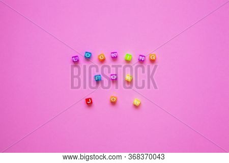 Colorful Letters Of Beads Concept. Quote Lookig For A Job On The Pink Background. Unemployment Conce