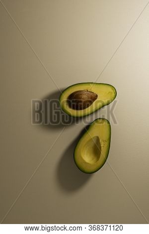 Ripe Avocado Fruit Cut In Half. Top View. Copy Space