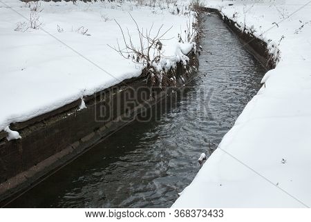 Urban Stream In Winter. The Lybid River (kyiv, Ukraine) In The Snow.