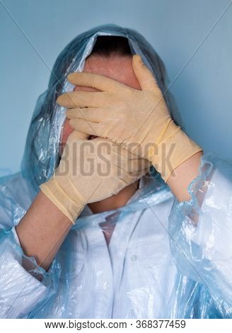 Woman In A Protective Suit Closing Her Face. Distressed Woman. Coronavirus (covid-19) Disease Outbre