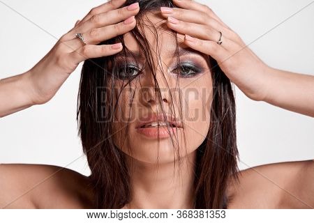 Beautiful Woman With Perfect Professional Make-up, Smokey Eyes On The Grey Background. Wet Hairs On 