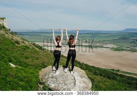 Girls Play Sports In The Mountains. Sport On The Pro-prod. Fitness In The Woods. Yoga In Nature.