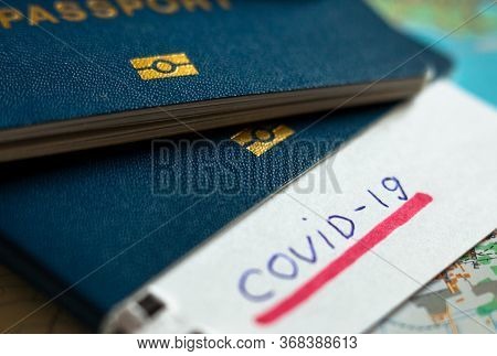 Passport And Note With Covid-19 Inscription. Coronavirus Disease Outbreak. Travelling In Epidemic Pe