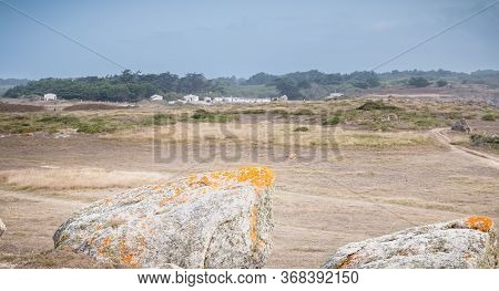 View Of The Rocky Dune Of Ile D'yeu Next To The Sea With Its Small Beach House, France