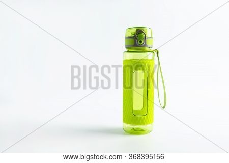 One Bright Green Plastic Fitness Sport Bottle Or Flask With Dispenser And Full Of Water On Light Gra