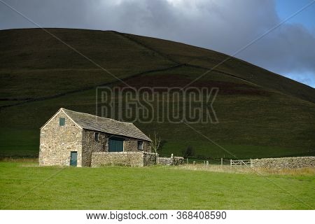 Stone Farm Building In The Peak District And Bright Sun.