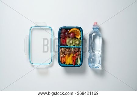 Top View of Full Lunch Box with Fuits, Vegetables and nuts.
