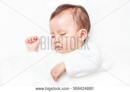 Newborn Sleeping On The White Bed (isolated On White Background)
