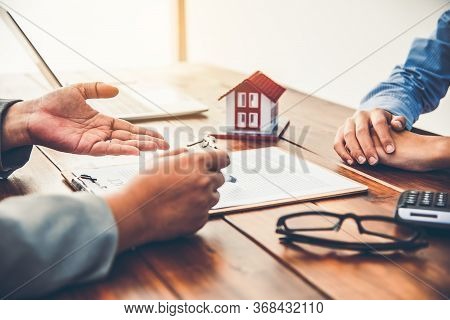 House Signers Signing Signature Loan Document To Home Ownership With Real Estate Agents Ownership. M