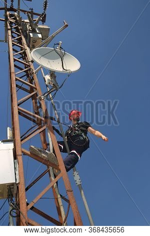 Worker Adjusts The Antenna For The High Power Scada System