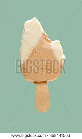 Cheese And Lemon Flavor Popsicle With Couple Of Bites On Green Background