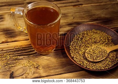Egyptian Yellow Tea Or Methi Dana Drink And Fenugreek Seeds On Wooden Table