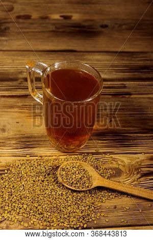 Egyptian Yellow Tea Or Methi Dana Drink And Fenugreek Seeds On Wooden Table