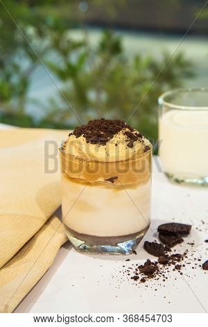 Home Made Dalgona Whipped Coffee With Cookies Crump In A Cup On White Table With A Cup Of Milk Blurr