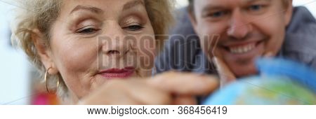 Elderly Mother Shows An Adult Son Location Globe. Find Old Friends Or Relatives With Whom You Lost C