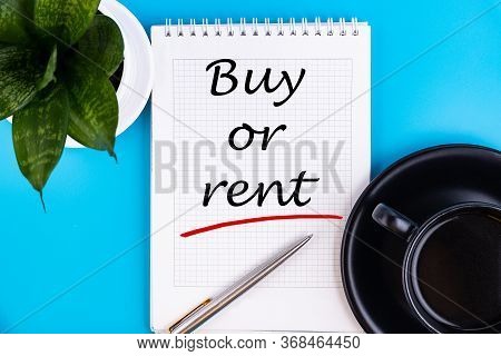 The Question To Buy Or Rent - Handwriting On Notebook With Cup Of Coffee, Business Concept