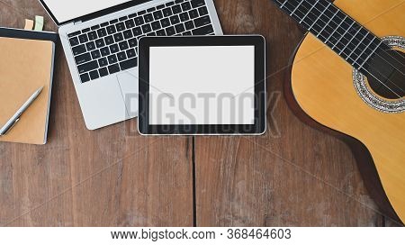 Working Desk Of Songwriter. Top View Of Note, Pencil, Laptop, White Blank Screen Tablet And Acoustic