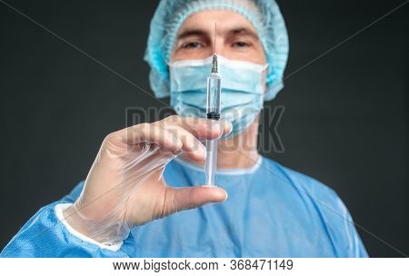 Confident Professional Male Anesthetist Holding Syringe With Dose Of Medicine While Working In Hospi