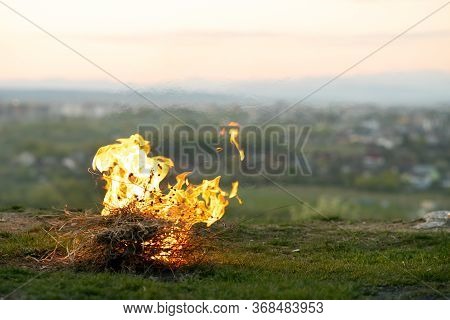 Big Bright Bonfire Bugning At Field In Evening.