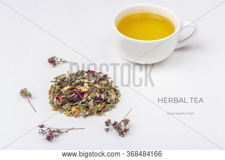Layout Of Cup Of Green Tea With Assortment Of Different Dry Tea Leaf And Flower Petals On A White Ba