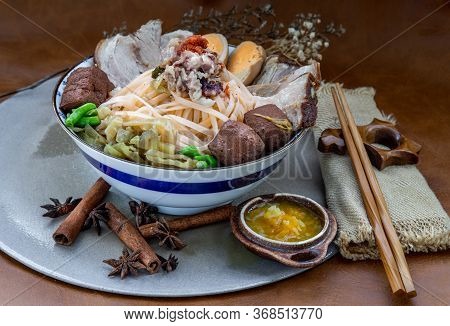 Traditional Chinese Sliced Stewed Pork Noodles With Pork Bone Broth And Boiled Egg, Tofu In Ceramic 