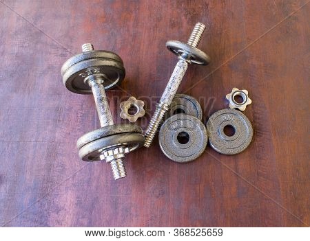 Top View Of A Dumbbells On A Wooden Background