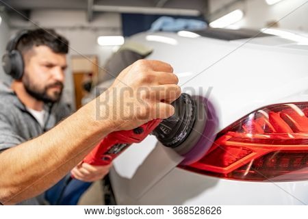 Polishing The Car Body With A Manual Automatic Grinder With Wax And Polishing Paste