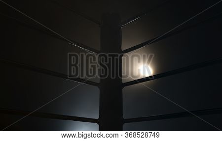 A Dramatic Closeup Of A Dimly Spotlit Corner Of A Boxing Ring Surrounded By Ropes On A Dark Isolated