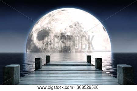A Wooden Boat Jetty Jutting Out Across Calm Water With A Full Moon Rising On The Horizon At Night - 