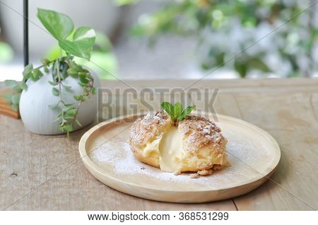 Choux Cream Or Cream Puff, Eclair In The Wooden Dish