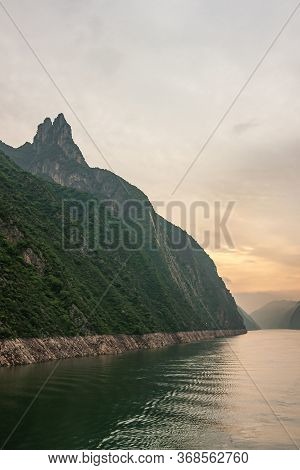 Wushan, Hubei, China - May 7, 2010: Wu Gorge In Yangtze River. Long View With Orange Lighted Sky Ove