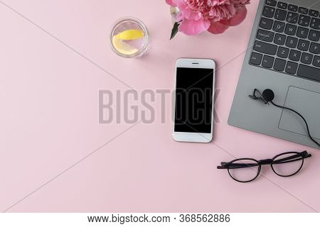 Podcast Recording, Microphone, Laptop, Phone, Water With Lemon And Glasses On A Pink Background With