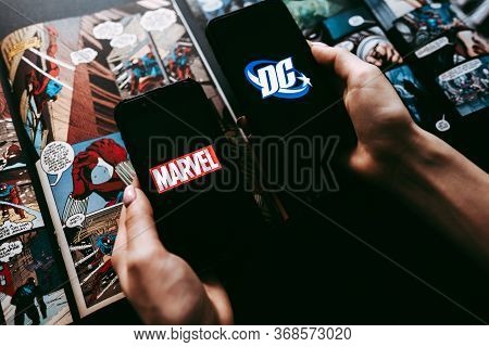 Marvel And Dc Comics Logo On The Comics Page Background.