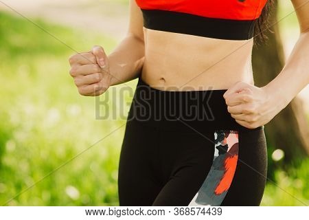 The Girl Runs In The Park On The Sunny Day. Outdoor Sports. Exercises For Tonus, Flexibility And Pow