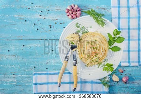 Beautifully-servered, Turquoise Wooden Table, On Which There Is A Plate With Italian Pasta With Chic