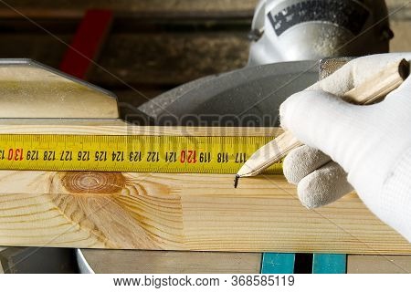 Closeup Of Professional Cabinet Makers Working Measuring Tape At Woodworking Workshop. Wood Material