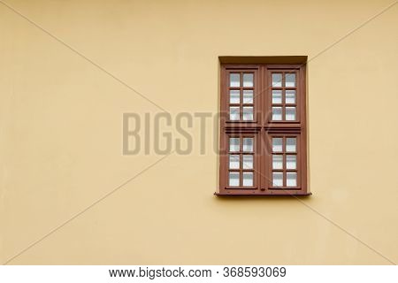 One Window Of A Cafe Restaurant In A Brown Plastic Frame Against A Yellow Plastered Wall. There Is R