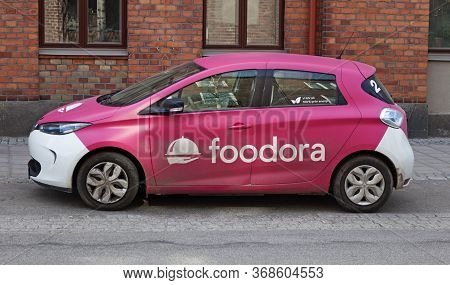 Umea, Norrland Sweden - April 21, 2020: Car Delivering Food To People In Corona Times