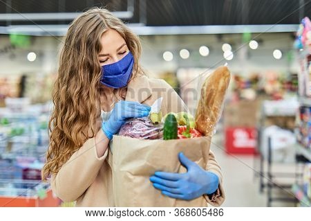 Woman Wiping Down Grocery Packages Wearing Gloves, Using Disinfecting Or Sanitizing Wipes. Shopping 