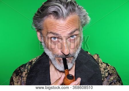 Portrait Of Al Mature Man Smoking A Pipe