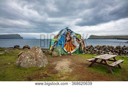 Eldgos And Frumskogur The Boulder Covered With Clothes In Sandoy Island